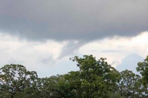 picture of a cloud with a possible tornado funnel forming.